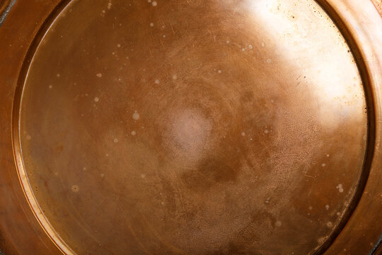Detailed view of an aged copper surface with light speckles and scratches