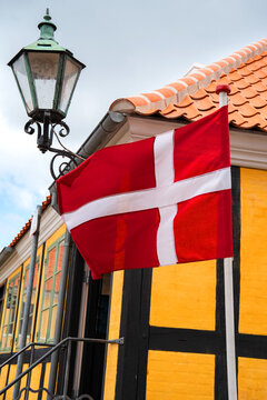 Danish flag waving in ebeltoft. National symbol in the old town of ebeltoft. Denmark.