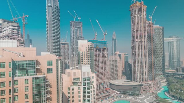 Metropolitan construction site aerial timelapse showcasing the environment in Downtown Dubai. The massive ongoing engineering projects are highly visible among the finished structures.