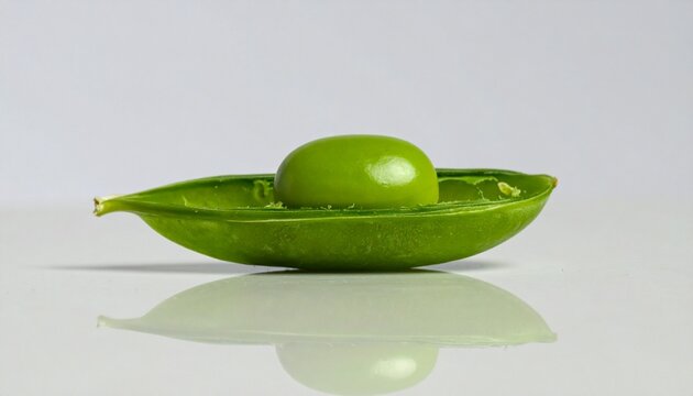 A single glossy green pea centered on a smooth light surface, reflecting light with a subtle highlight, symbolizing simplicity, minimalism, and natural freshness in a clean composition.