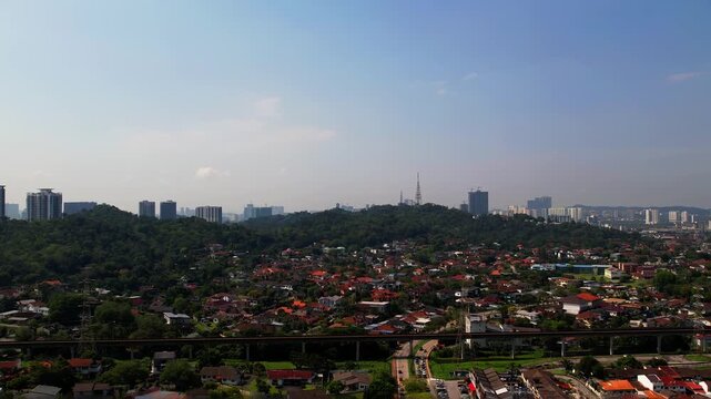 Petaling Jaya, Malaysia - April 8, 2023 Small mountains, drone view near township.
