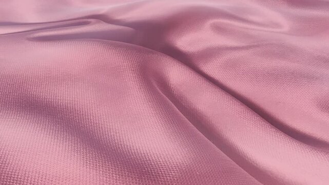 Elegant pink satin fabric waving in slow motion, abstract silk background