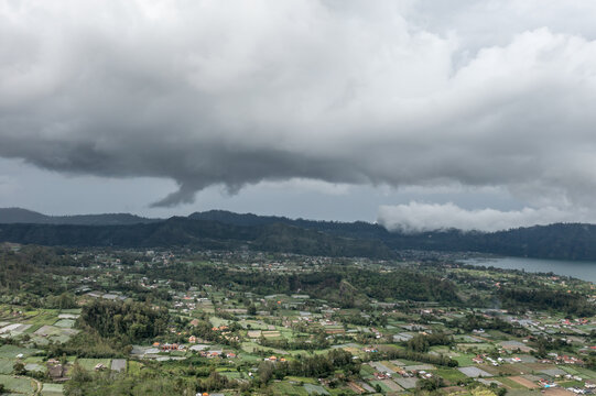 Aerial View of Bali Lake Coastline and Villages Beneath Low Clouds