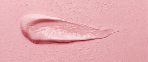 Fototapeta premium Light pink cream smeared on a textured surface