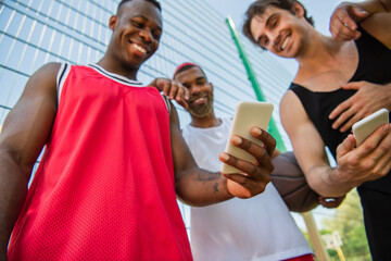 Fototapeta premium Multicultural friends enjoying basketball moments on a sunny summer day