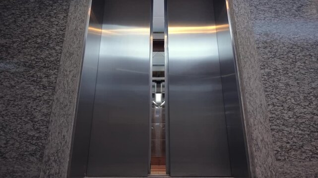 Modern elevator opening and closing loop in office lobby