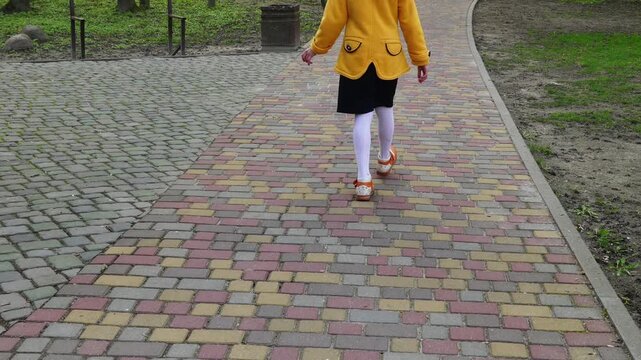 Little girl goes on cobbled pavement
