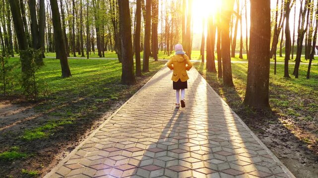 Little girl goes on cobbled pavement