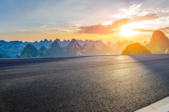 Empty asphalt road and majestic karst mountain peaks at sunset in Guilin, China