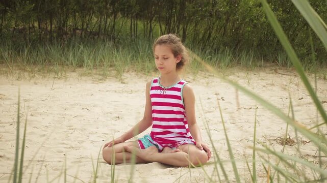 Little girl walks on sandy beach, Jurmala, Latvia