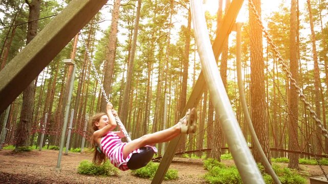 Small girl with helmet in adventure park