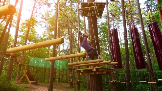 Small girl with helmet in adventure park