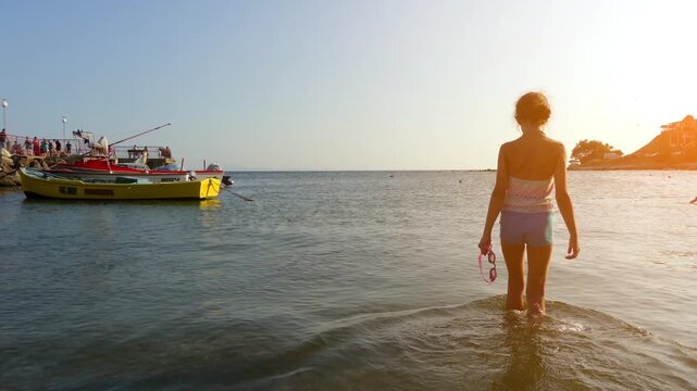 beautiful girl in a bathing suit in the water on the beach of the Black Sea in the city of Nessebar, Bulgaria.