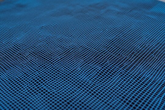 A close up of a blue wire mesh fence