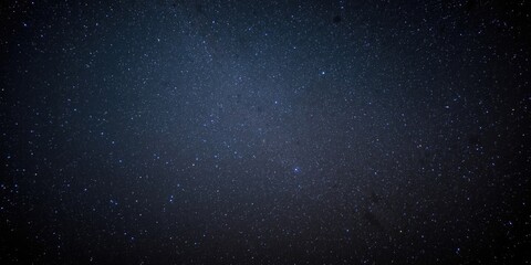 Fototapeta premium Starry night sky with twinkling stars on dark background