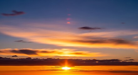 Fototapeta premium Stunning golden hour sunrise over a calm ocean horizon.