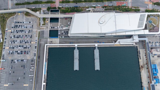 Aerial view of the Busan Port International Passenger Terminal Cruise Terminal featuring modern architecture, a large parking lot, and harbor piers in Busan, Busan, South Korea.