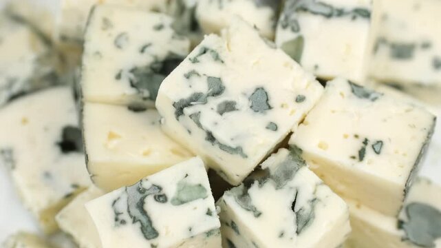 Blue cheese. Heap of sliced blue cheeses with a noble mold, rotate