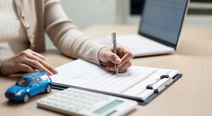 Insurance agent completing car insurance application form with calculator and vehicle model, highlight auto coverage, policy enrollment, premium calculation, financial protection, and claims planning. © Father_Studio