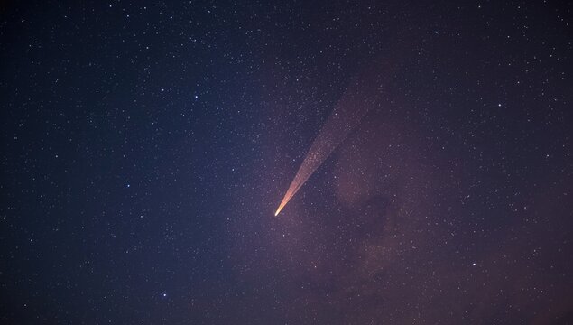 Double meteorites blaze fiery paths across the star filled night sky