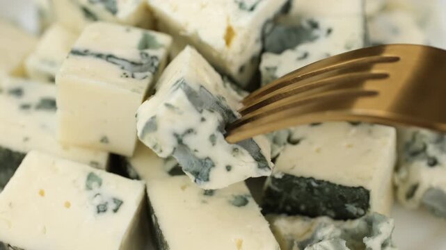 Eating with fork blue cheeses with a noble mold