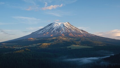 Fototapeta premium Snow capped volcanic mountain towering over forested hills