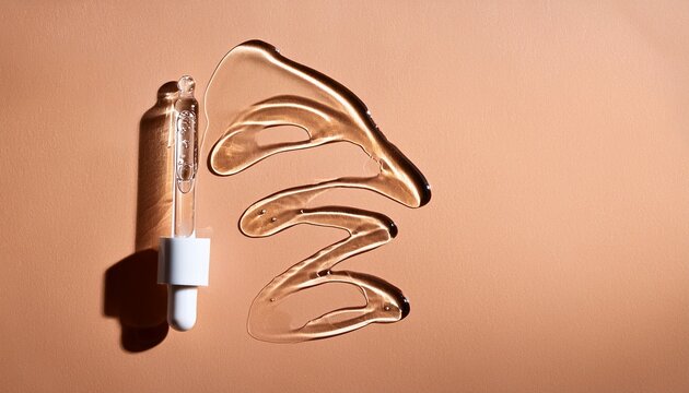 pipette drop of serum test samples of cosmetic care products smears of cream gel texture on a beige background