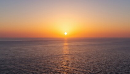 Obraz premium Sunset over calm ocean waters