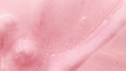 Fototapeta premium Soft pink liquid texture background featuring a smooth tactile finish and copy space