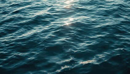 Obraz premium Rippling blue ocean water with sunlight reflections