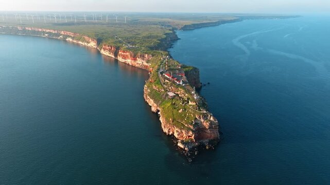 Cape Kaliakra aerial panoramic view Black Sea coast Bulgaria long rocky peninsula drone shot sunset warm light red cliffs ocean water horizon travel agent banner web header advertising background