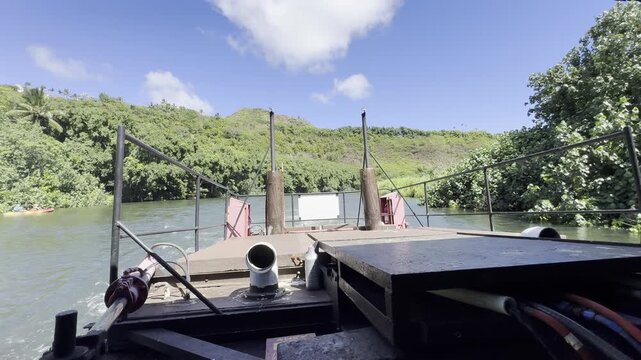 21 October 2024, USA, Hawaii, The Garden Isle, Kauaʻi, Kapaa, Wailua River - fern grotto tourist boat tour cruise boat rear-engine system overlooking riverbank