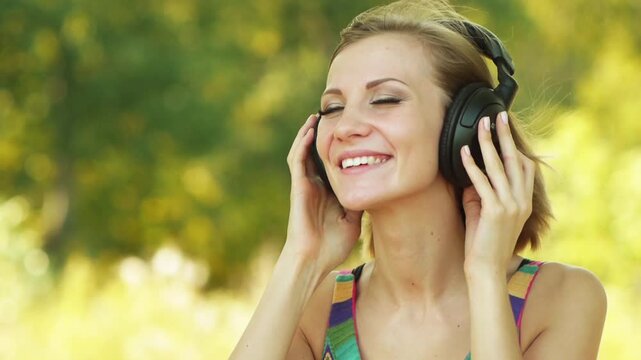 Young woman listening to music on headphones