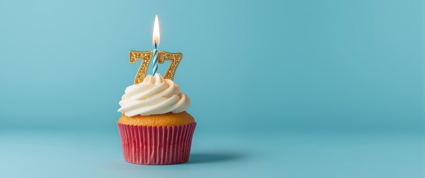 Cupcake with a burning candle for a 77th birthday celebration