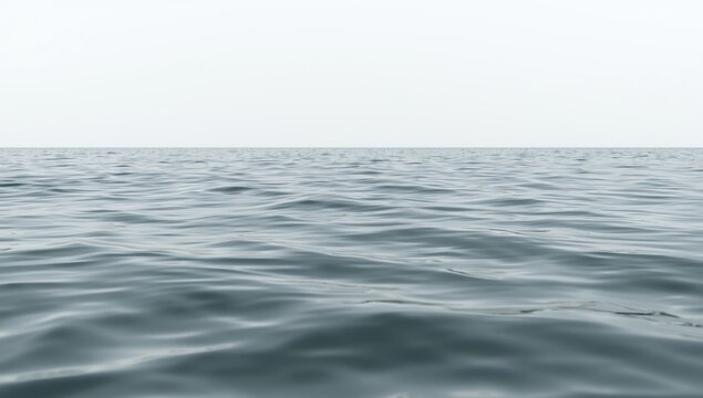 Still sea water exhibiting soft undulating waves with a simple white background