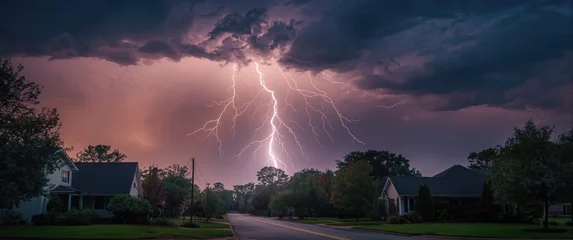 Lightning striking over a quiet suburban street at dusk © vxnaghiyev