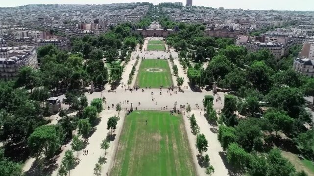 Bastille Day top-down aerial Champ de Mars Paris, Eiffel Tower foot shadow on grass, formal geometric park, bird's eye view, cinematic France July 14 drone b-roll