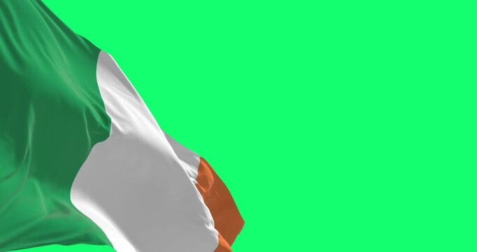 Ireland national flag waving in the wind isolated on green background