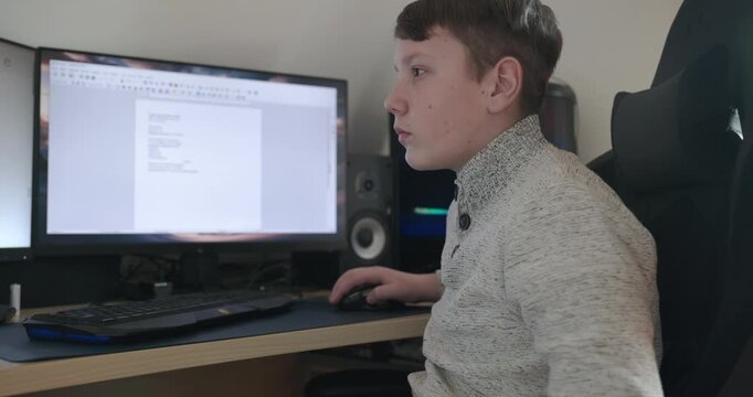 Kid Boy Use Desktop Computer for Study Typing and Reading. 4K 10-bit