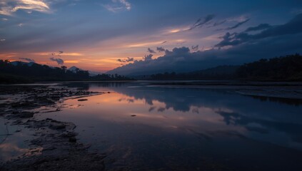 Fototapeta premium Twilight over a serene river with mountain reflections