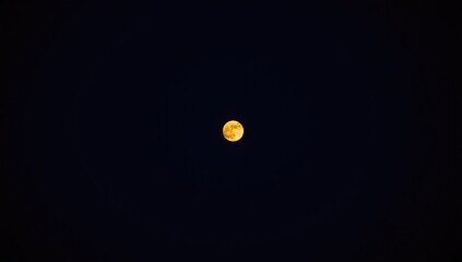 Fototapeta premium Full moon glowing against a dark night sky