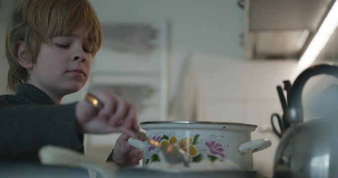 Kid Boy Prepares Rice for Meal in Kitchen. 4K 10-bit