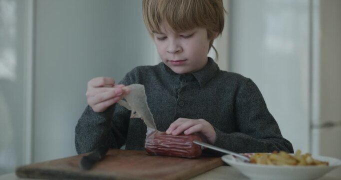 Kid Boy Cut Sausage Using Knife. Eating Breakfast Lunch in Kitchen. 4K 10-bit