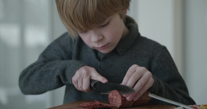 Kid Boy Cut Sausage Using Knife. Eating Breakfast Lunch in Kitchen. 4K 10-bit
