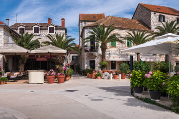 Obraz premium Cozy cafe terraces on old stone square in Jelsa town, Hvar island