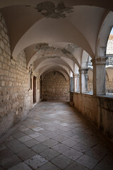 Fototapeta premium Ancient stone arcade corridor in the Franciscan monastery in Hvar