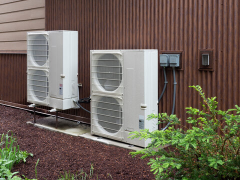 Heat pumps outside a house in a modern setting
