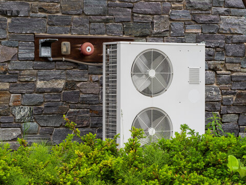 Heat pumps outside a house in a modern setting
