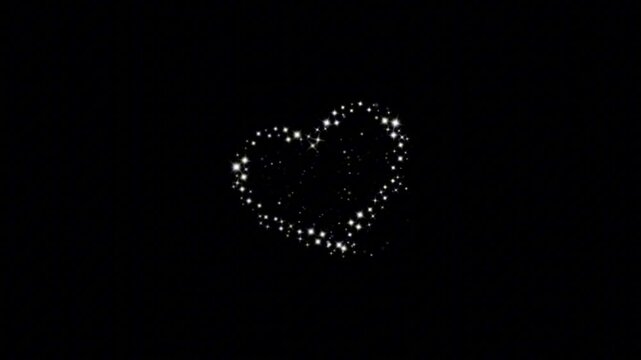 Glowing heart made of sparkling lights on dark background. Symbol of love, romance, and affection. Abstract design for valentines, anniversaries, or emotional themes