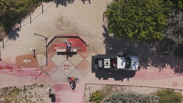 Aerial view of a worker pressure cleaning a beach entrance floor